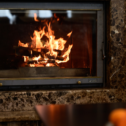 Bukovel, Ukraine February 2, 2021_ a burning fireplace in the lobby of the hotel, winter vacation in a warm hotel, a warm winter atmosphere. a burning fireplace in the lobby of the hotel, winter vacation in a warm hotel, a warm winter atmosphere